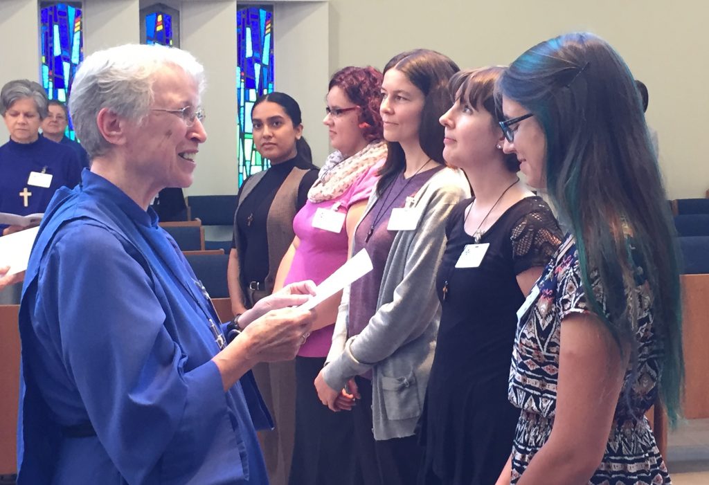 Sister Elizabeth Rolfe-Thomas, Reverend Mother for the Sisterhood of St. John the Divine, presents the Companions on the Way with individual crosses to wear. Photo by Matt Gardner